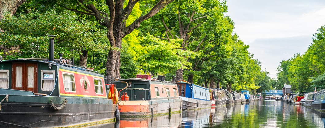 row of narrowboats on canal