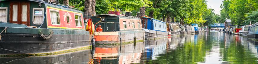 row of narrowboats on canal