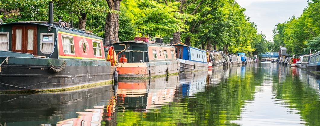 row of narrowboats on canal